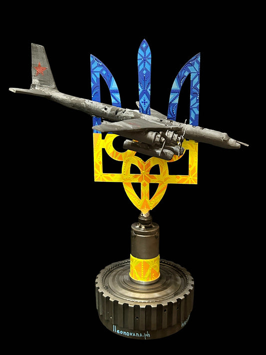 TU-95 aircraft model impaled on Tryzub sculpture by Hisoshi Art Studio