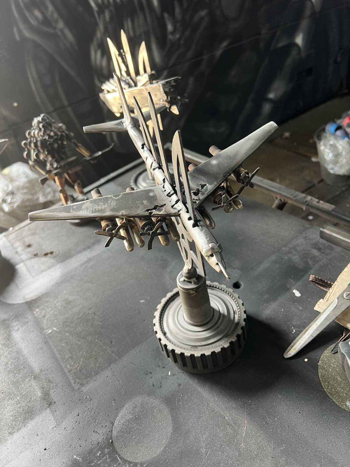 TU-95 aircraft impaled on Tryzub sculpture designed by Hisoshi Art Studio