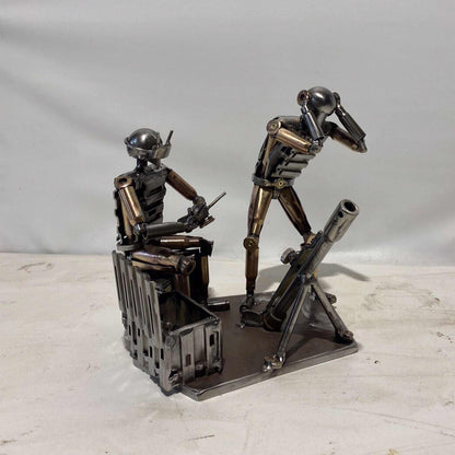 Sculpture of Ukrainian FPV drone operator and infantryman firing mortar made from frontline shells