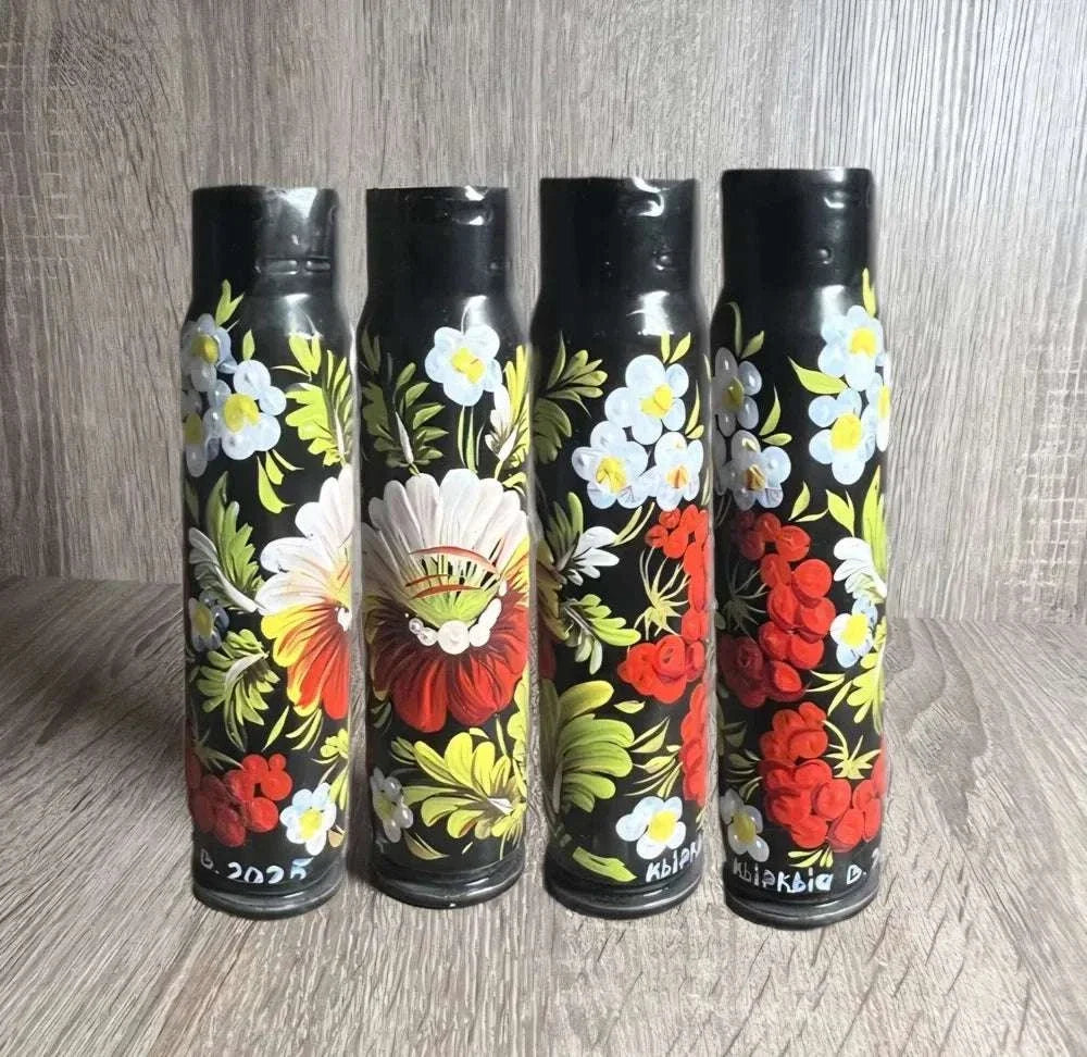 Ukrainian reward system 30 mm shell casing, black with hand-painted red and white flowers, yellow-green leaves and a central basket motif