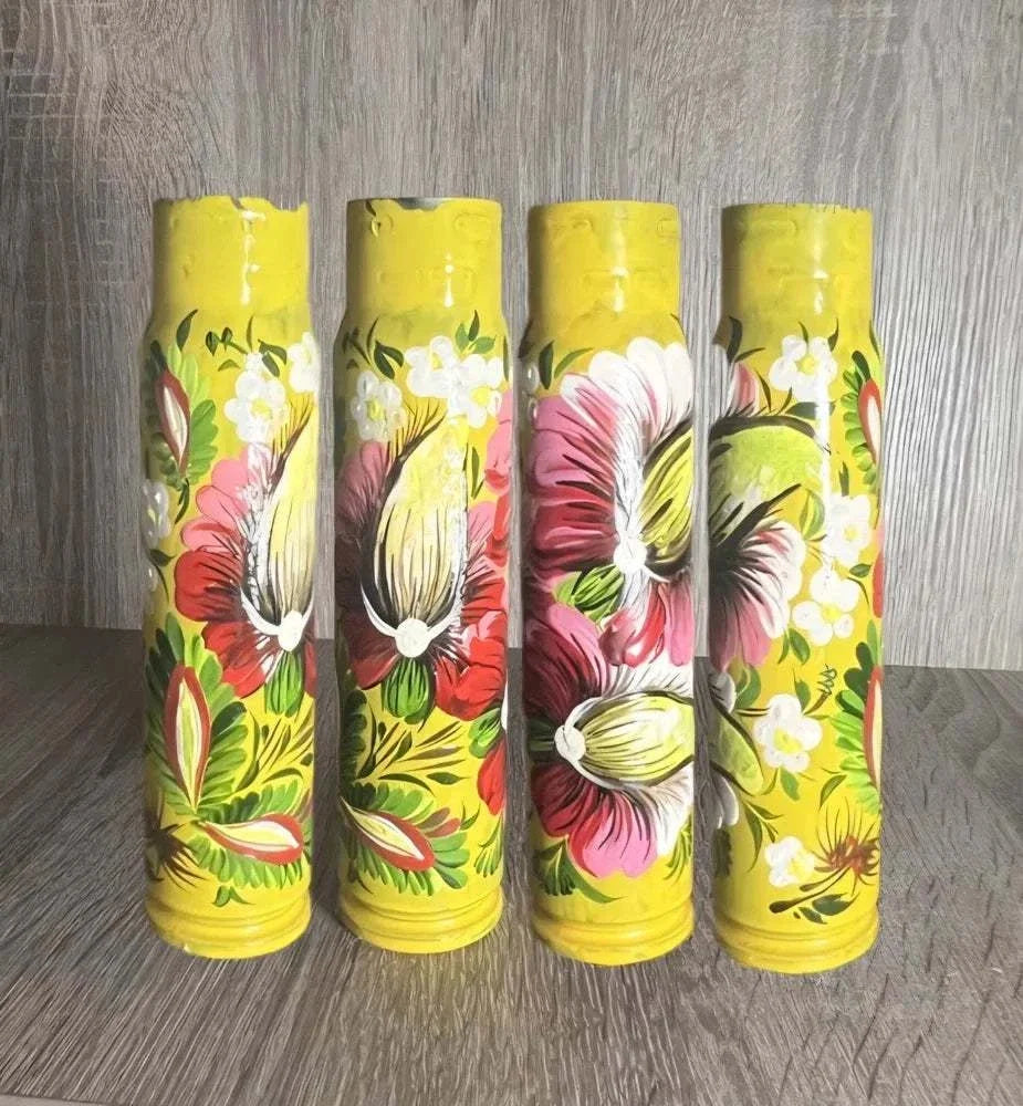 Ukrainian reward system featuring four yellow shell casings hand-painted with colorful floral patterns and blossoms