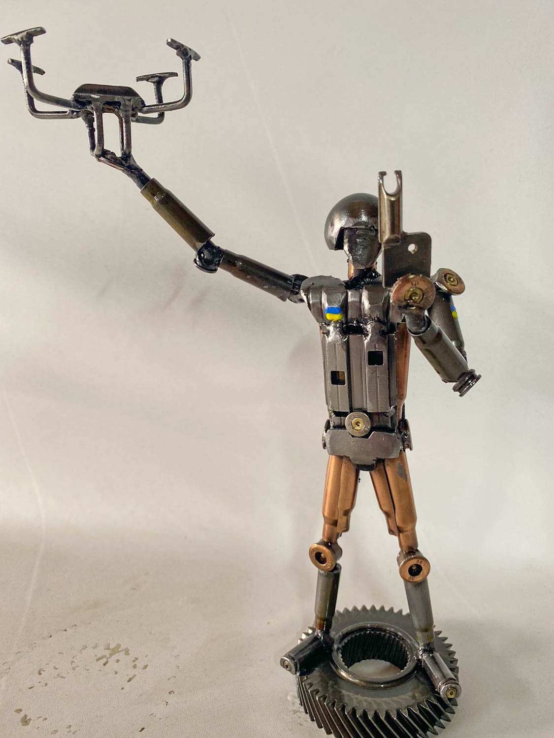 Sculpture of Ukrainian soldier launching drone made from frontline shells, 27cm tall