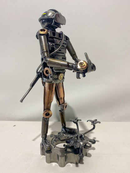 Sculpture of Ukrainian soldier operating FPV drone made from frontline shells