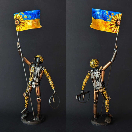 Sculpture of Ukrainian soldier holding flag made from frontline shells, 27cm tall