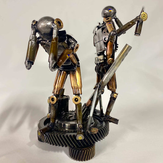 Sculpture of two Ukrainian soldiers loading a mortar shell by Hisoshi Art Studio