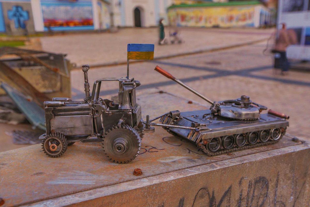 Ukrainian tractor pulling a Russian tank artwork by Hisoshi Art Studio