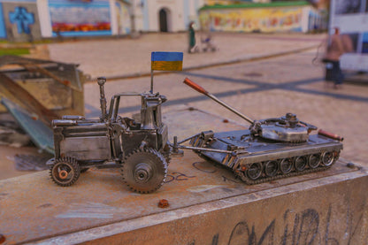 Ukrainian tractor pulling a Russian tank artwork by Hisoshi Art Studio